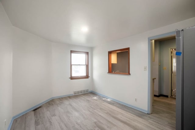 unfurnished room featuring light wood-type flooring