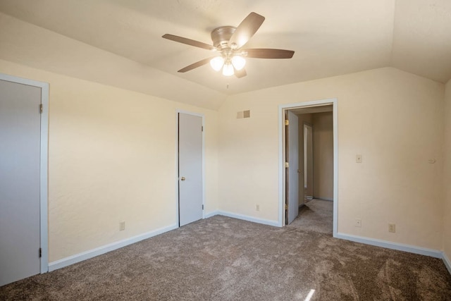 carpeted spare room featuring lofted ceiling and ceiling fan