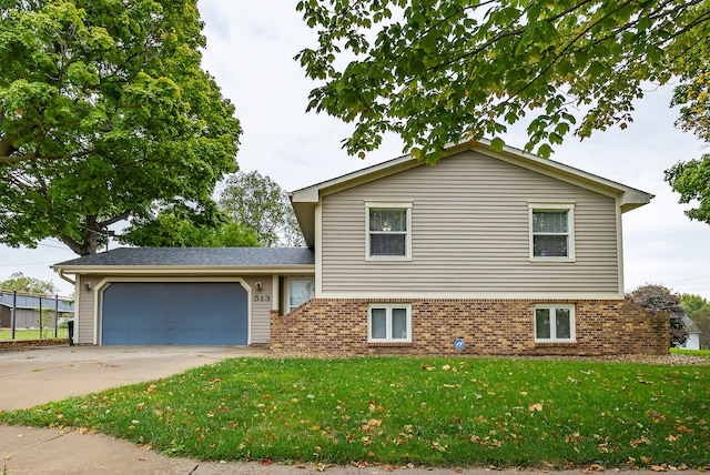 split level home with a garage and a front yard