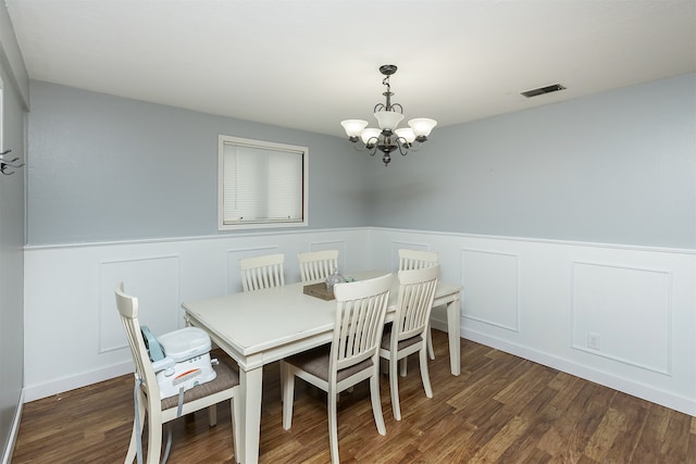 dining room with an inviting chandelier and dark hardwood / wood-style flooring