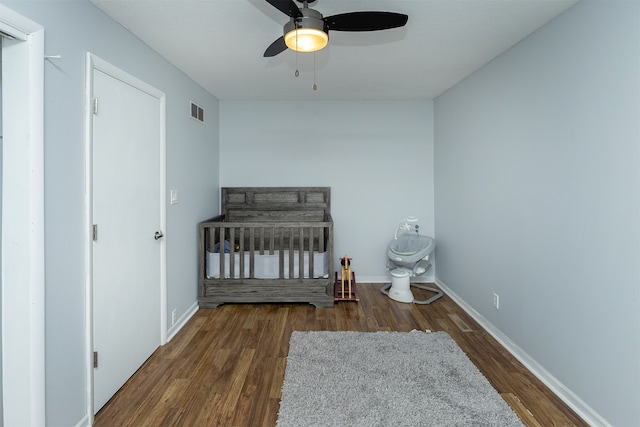 bedroom with ceiling fan and dark hardwood / wood-style flooring