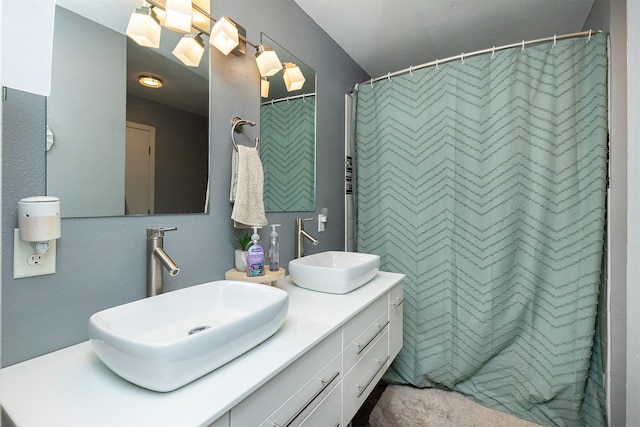 bathroom featuring walk in shower and vanity