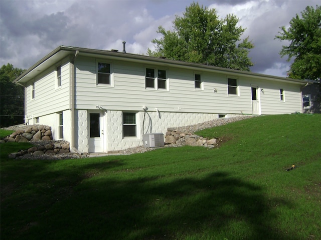 back of house with a lawn and central AC unit