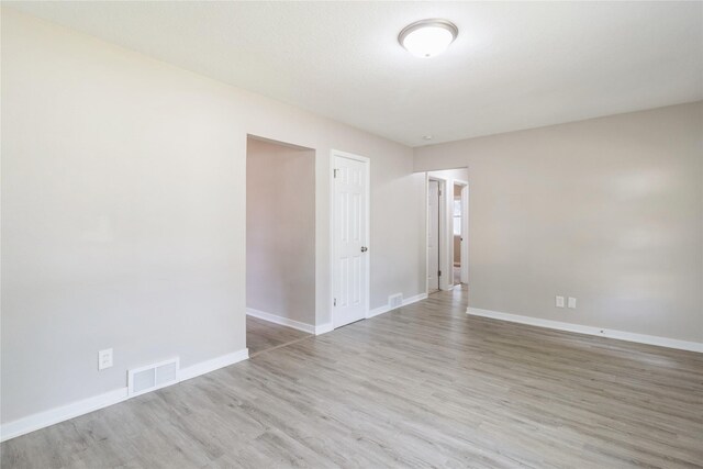 empty room with light hardwood / wood-style floors