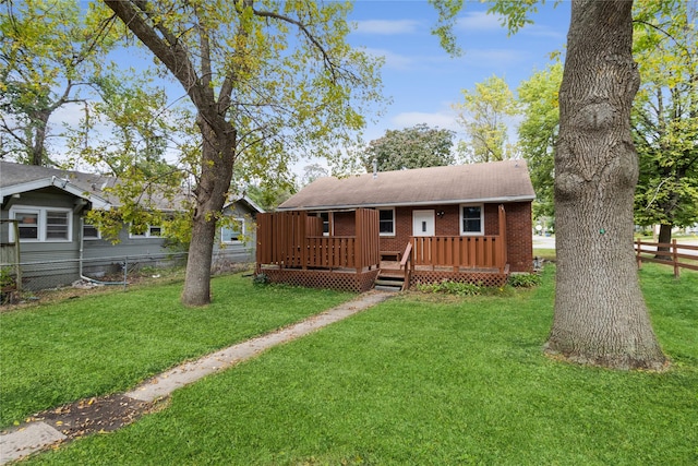 view of front of house featuring a front yard and a deck