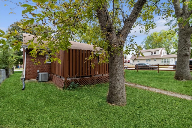 view of yard featuring cooling unit and fence