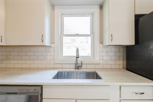 kitchen with white cabinets, dishwasher, backsplash, and a wealth of natural light