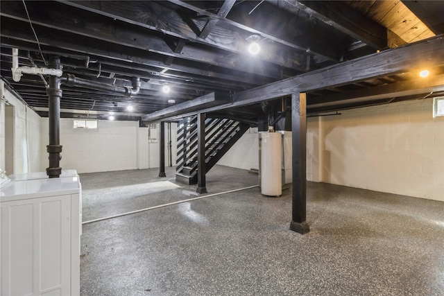 basement featuring washer / clothes dryer, gas water heater, and stairs