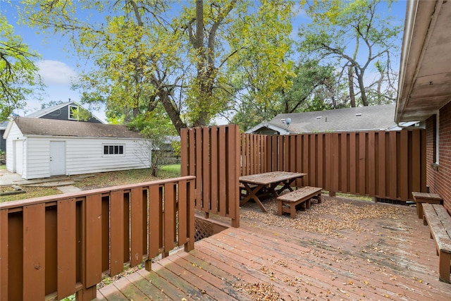 wooden terrace featuring outdoor dining area and an outdoor structure