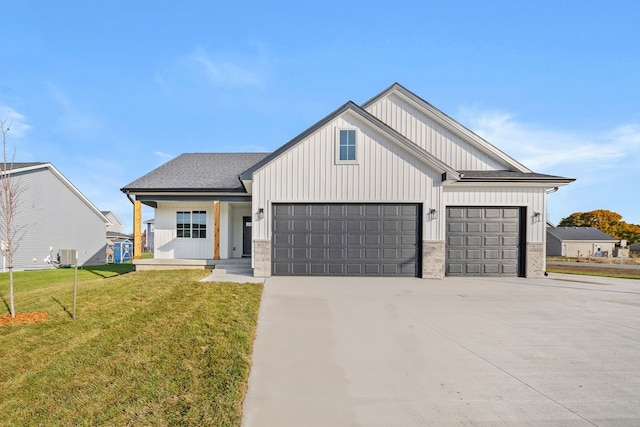 modern inspired farmhouse featuring a garage and a front yard