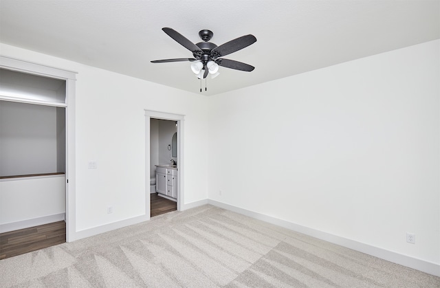 unfurnished bedroom featuring ceiling fan, connected bathroom, and carpet