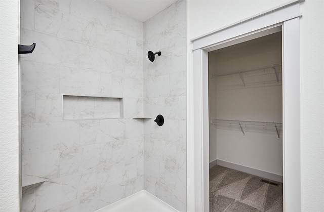 bathroom with a tile shower