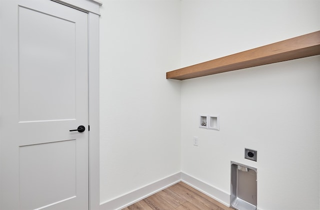 clothes washing area with electric dryer hookup, washer hookup, and light hardwood / wood-style flooring