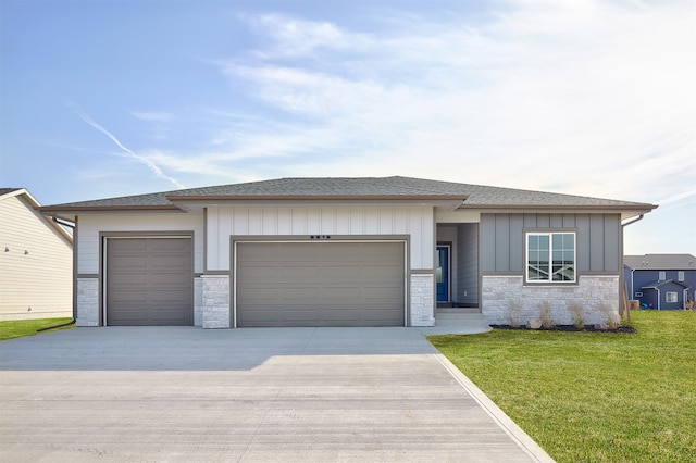 prairie-style home featuring a front yard and a garage