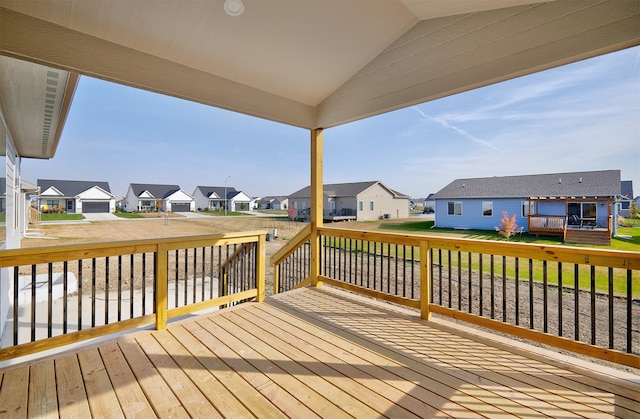 wooden terrace featuring a garage and a yard