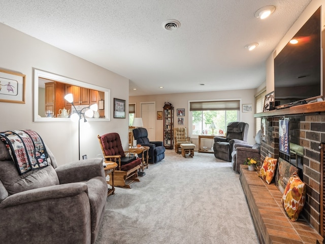 carpeted living room featuring a textured ceiling and a fireplace