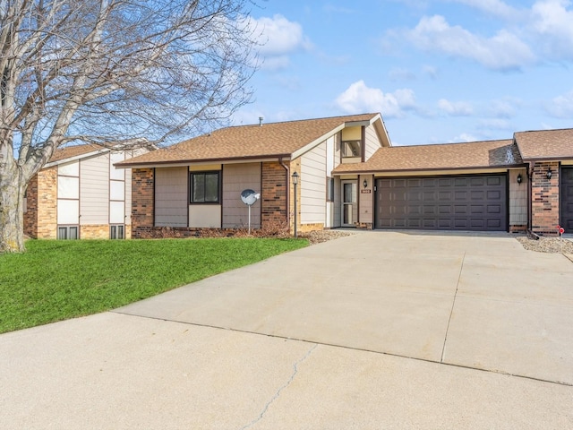 view of front of home with a garage and a front lawn