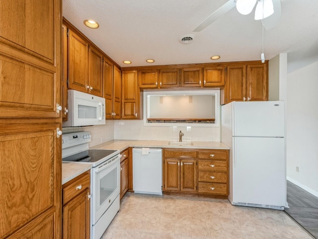 kitchen featuring tasteful backsplash, sink, white appliances, and ceiling fan