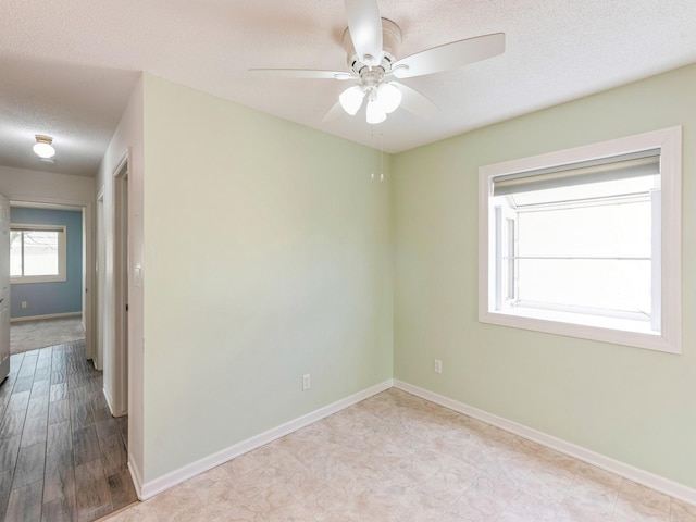 spare room with ceiling fan and a textured ceiling