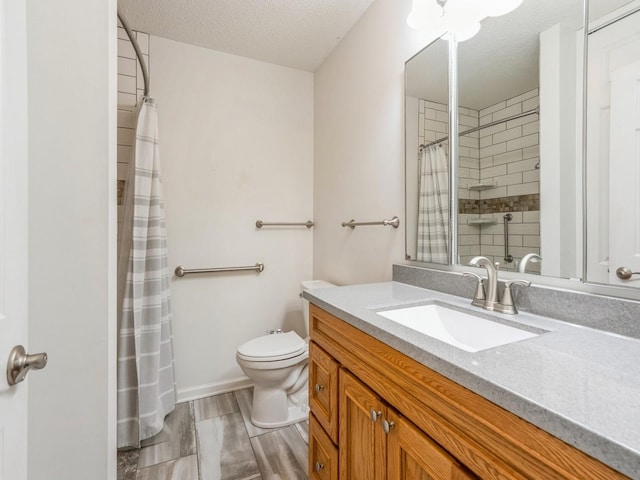 bathroom featuring walk in shower, vanity, toilet, and a textured ceiling