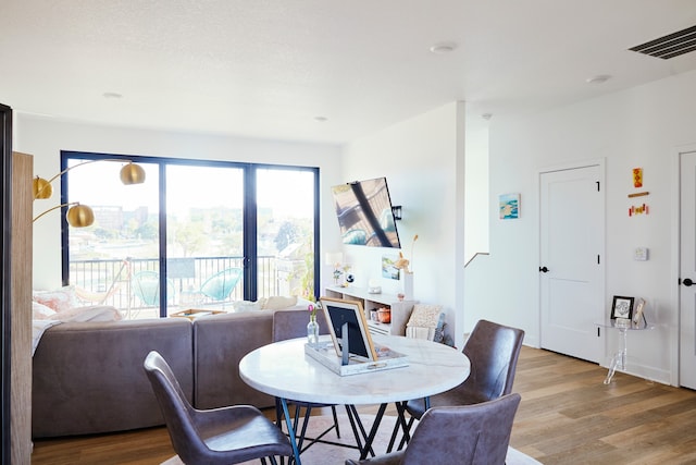 dining space with light wood-type flooring