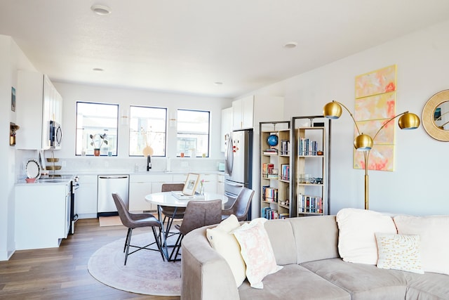 living room featuring hardwood / wood-style floors and sink