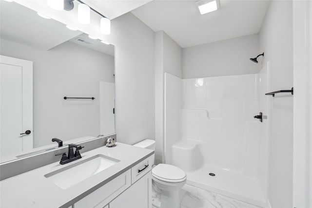 bathroom featuring vanity, toilet, and walk in shower