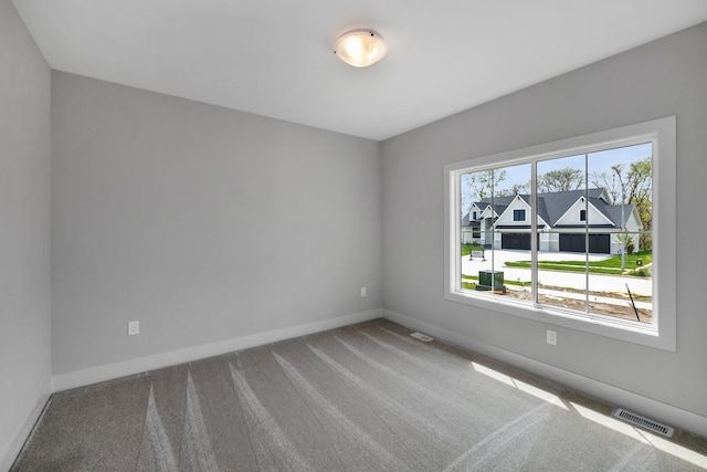 unfurnished room with a healthy amount of sunlight and carpet