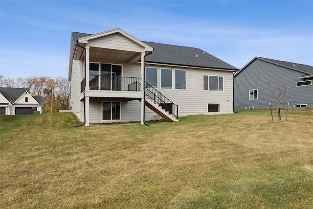 rear view of house featuring a yard