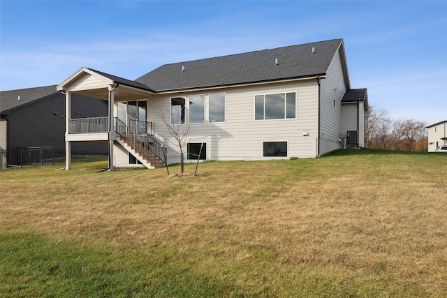 rear view of property featuring a yard