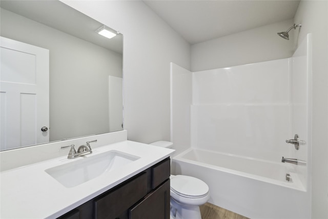 full bathroom featuring wood-type flooring, toilet, vanity, and shower / washtub combination