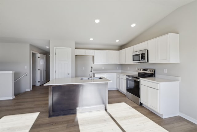 2105 White Oak Ln, Granger, IA 50109 - kitchen featuring appliances with stainless steel finishes, a kitchen island with sink, vaulted ceiling, light wood-style flooring, and recessed lighting