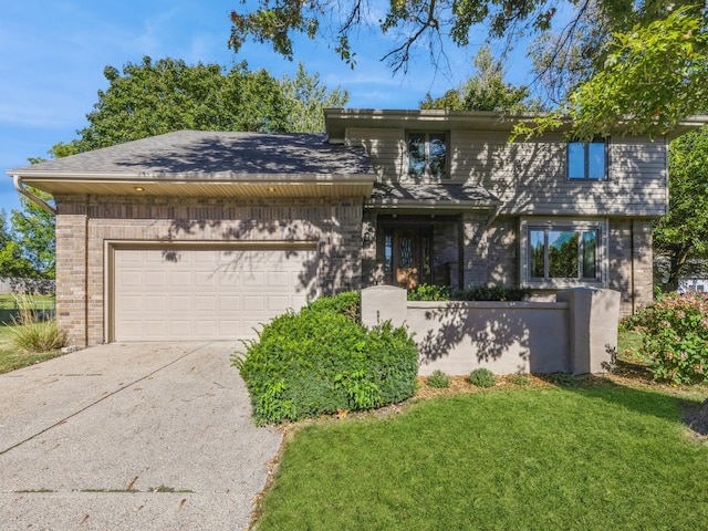 view of front of property with a garage and a front yard