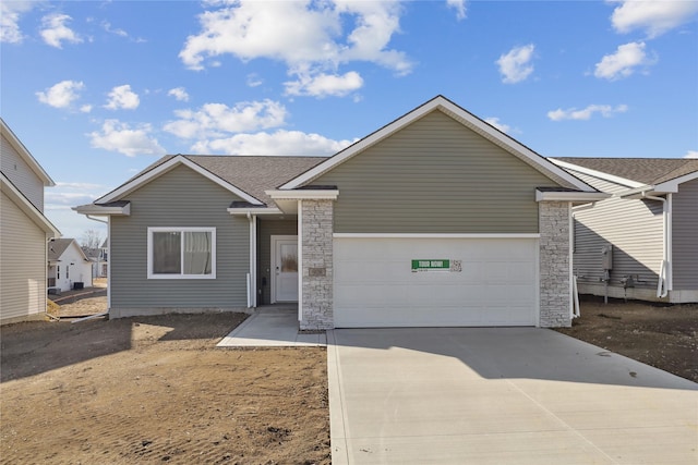 ranch-style home featuring concrete driveway, a shingled roof, an attached garage, and stone siding