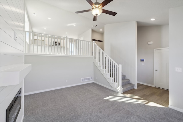 stairway featuring high vaulted ceiling, visible vents, ceiling fan, and baseboards