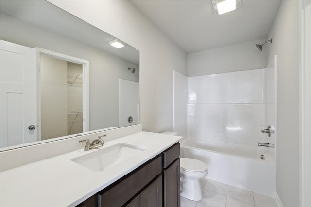 bathroom with shower / bathtub combination, tile patterned flooring, toilet, vanity, and a walk in closet