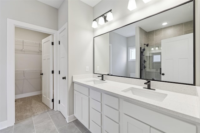 bathroom featuring tile patterned flooring, vanity, and walk in shower