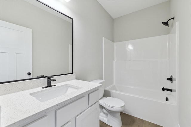 full bathroom featuring vanity, toilet, wood-type flooring, and shower / washtub combination