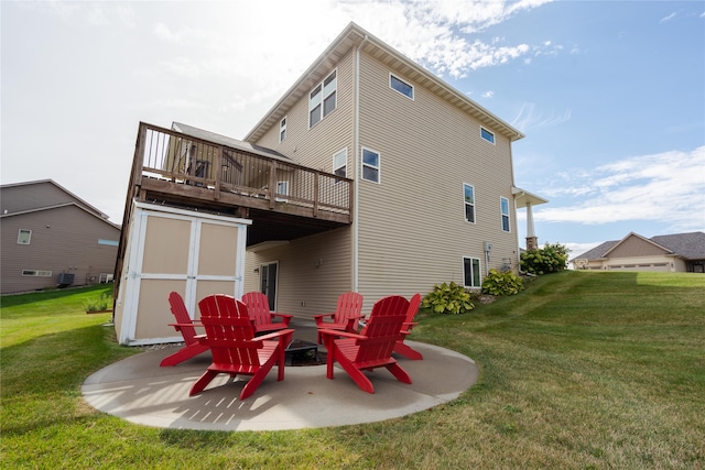 back of house with a deck, a lawn, and a patio