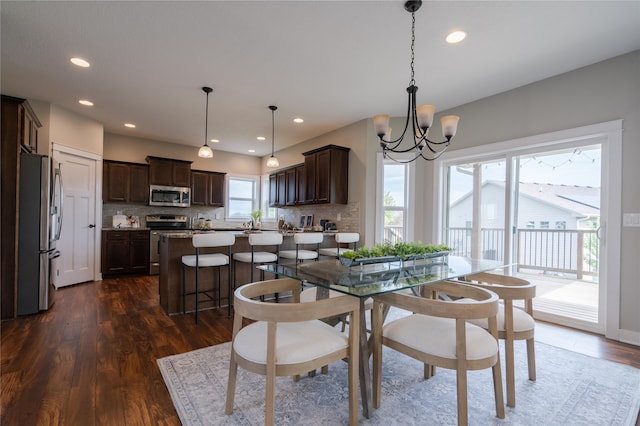 dining room with an inviting chandelier and dark hardwood / wood-style floors