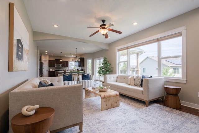 living room with ceiling fan and light wood-type flooring