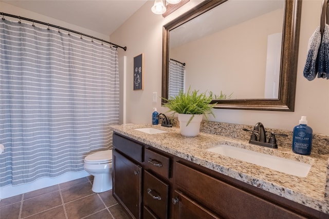 bathroom with vanity, tile patterned flooring, toilet, and curtained shower