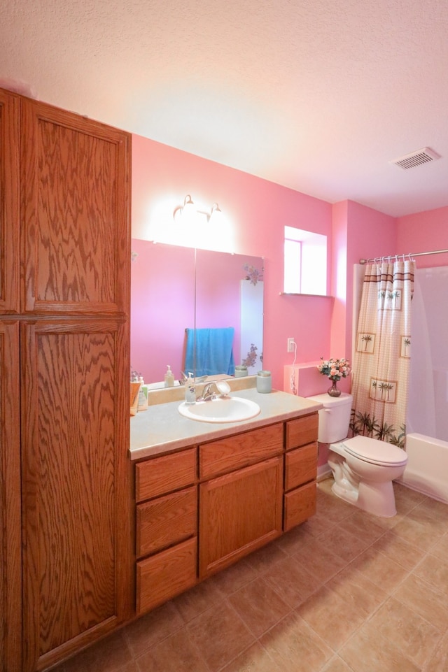 full bathroom with shower / bath combination with curtain, tile patterned flooring, vanity, and toilet