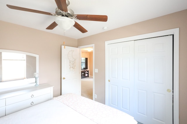 unfurnished bedroom featuring carpet, ceiling fan, and a closet