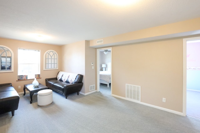 living room with light carpet and ceiling fan