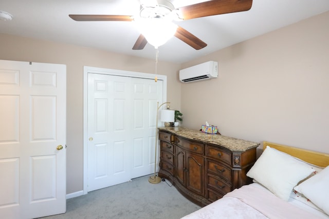 carpeted bedroom featuring ceiling fan, a closet, and a wall unit AC