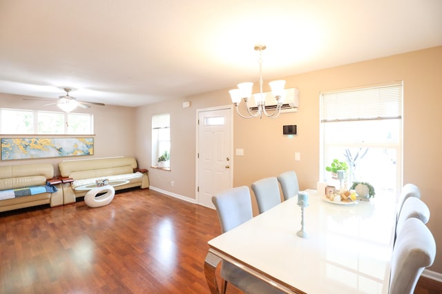 dining space featuring ceiling fan with notable chandelier, an AC wall unit, and dark hardwood / wood-style flooring