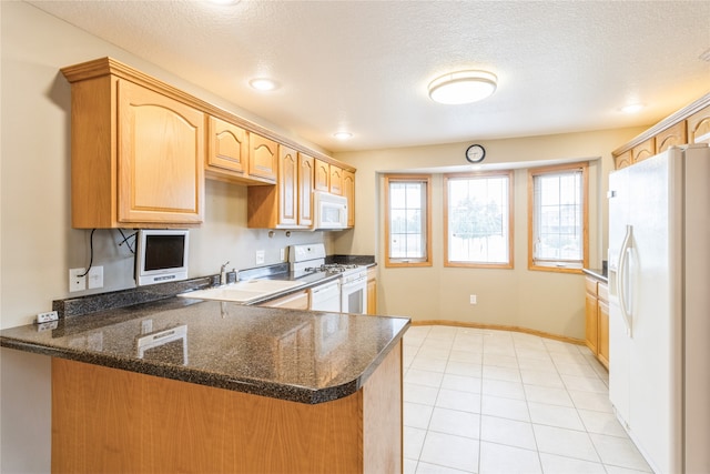 kitchen featuring sink, a textured ceiling, kitchen peninsula, and white appliances