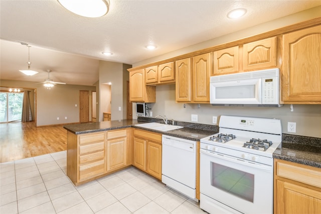 kitchen with white appliances, ceiling fan, light tile patterned floors, and sink