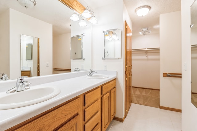 bathroom with a textured ceiling and vanity